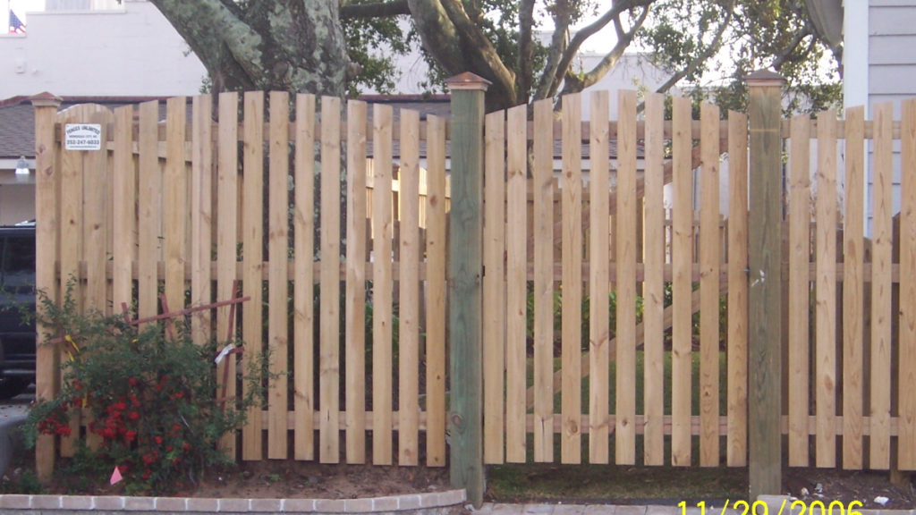 Rainbow picket with copper post caps Morehead City residential fence